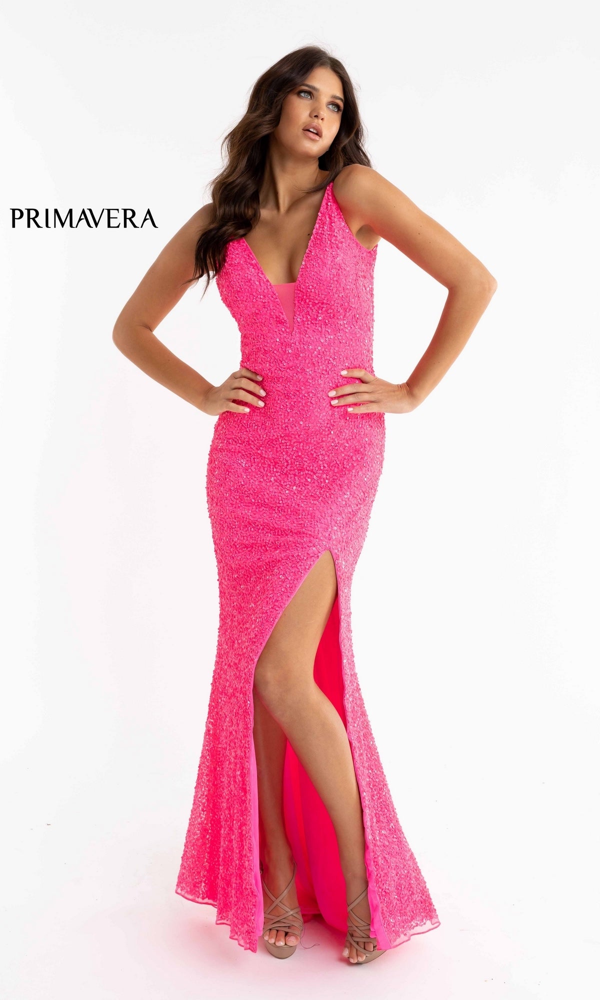 A woman poses with one hand on her hip against a white background, wearing the Bright Sequin-Print Long Prom Dress 3792B—a vibrant, sleeveless gown featuring a floor-length design and a thigh-high slit.